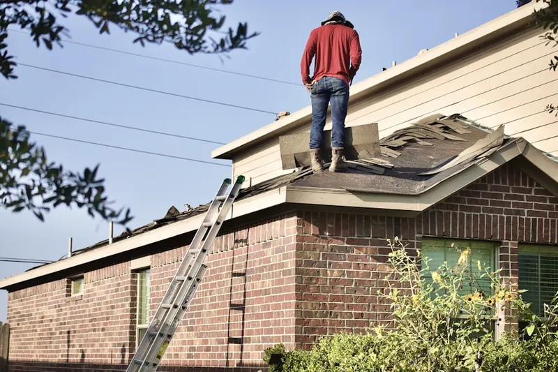 Professional roofer working on a residential roof in South Central Beach